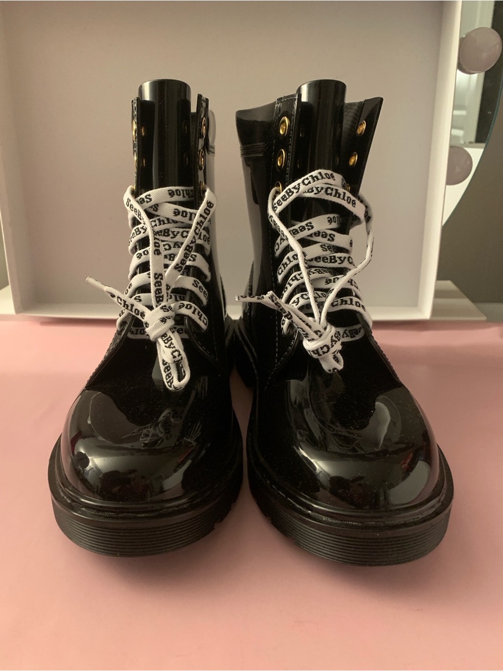 See By Chloé Black glossy rain boots with branded shoestrings and chunky soles.